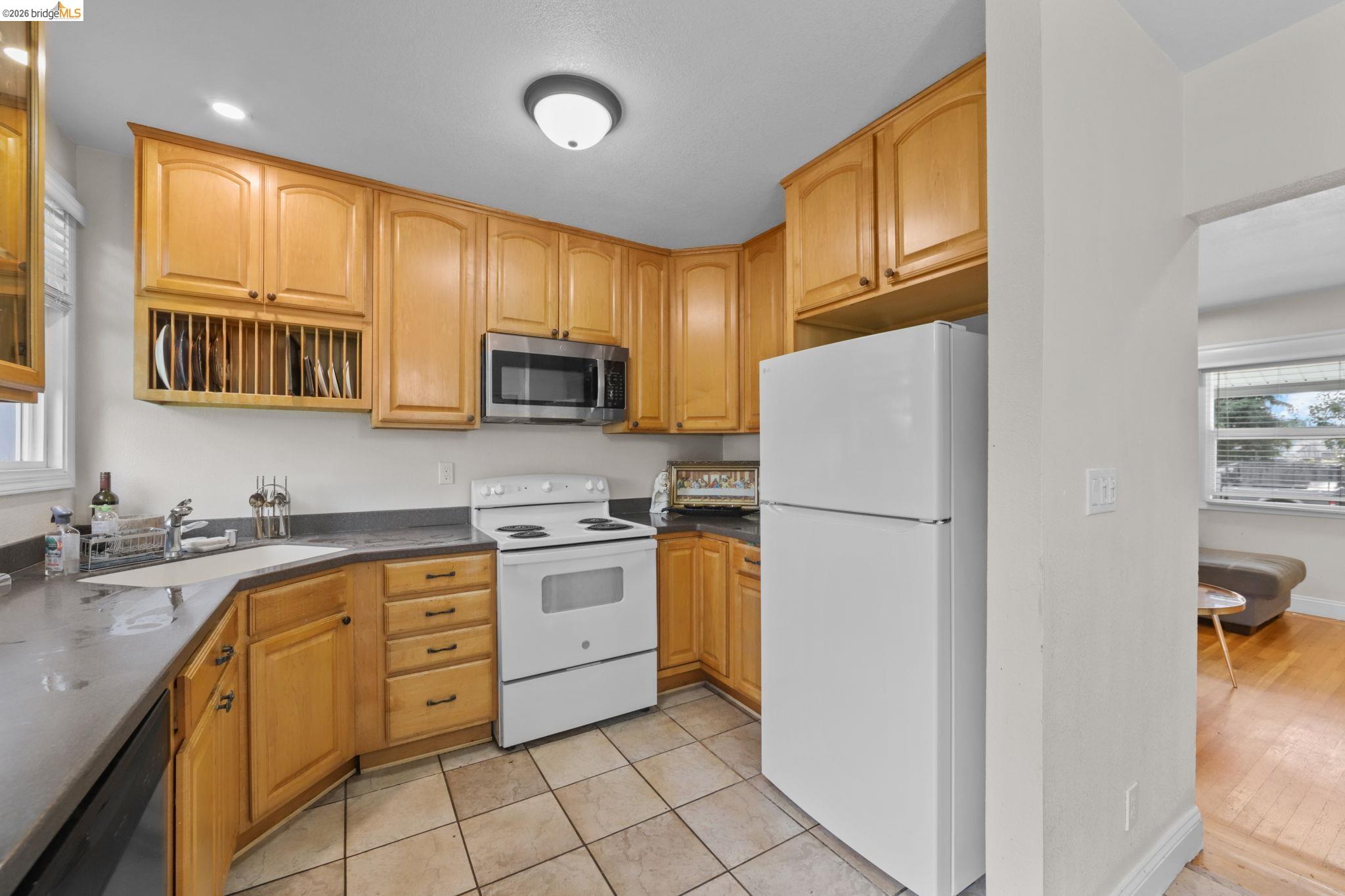 104 Foster Street Vallejo, CA 94591 - Photo 33 of 34 a kitchen with stainless steel appliances granite countertop a refrigerator sink stove microwave and cabinets