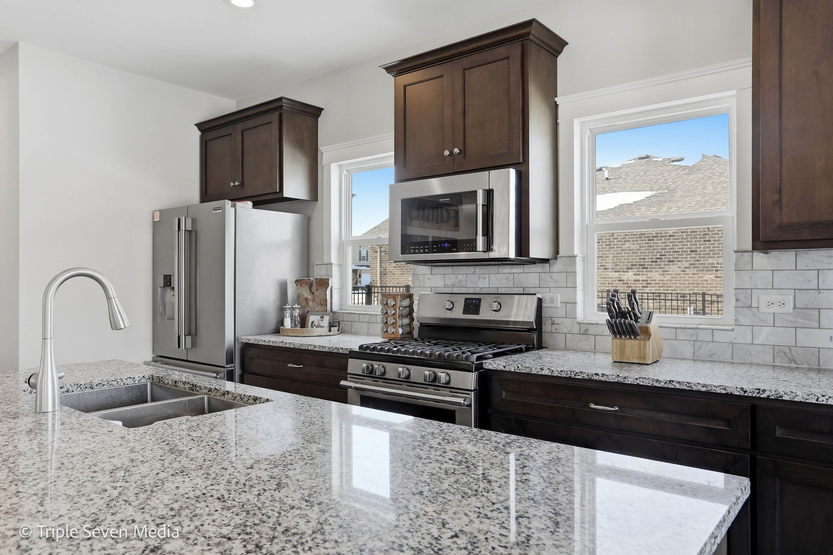 16256 Pinto Lane Manhattan, IL 60442 - Photo 13 of 32 a kitchen with stainless steel appliances granite countertop a stove a sink and a microwave