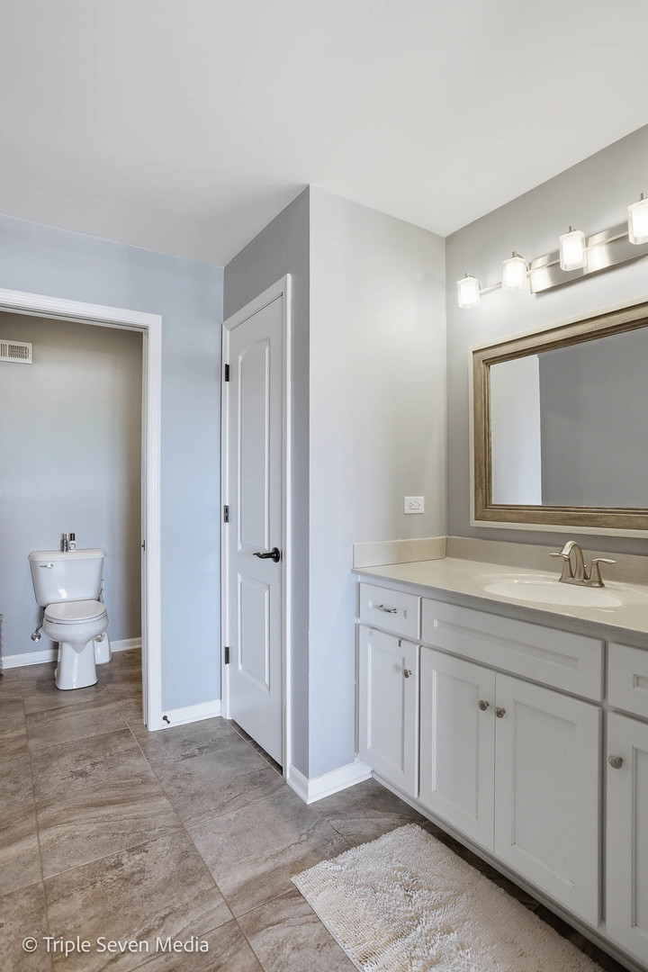 16256 Pinto Lane Manhattan, IL 60442 - Photo 18 of 32 a bathroom with a toilet sink and mirror