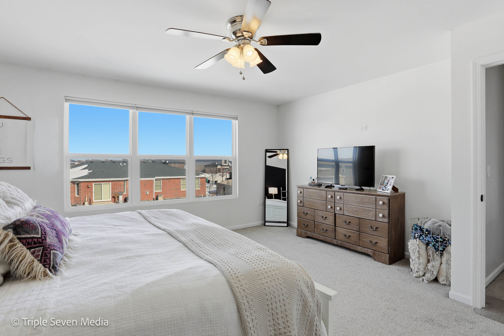16256 Pinto Lane Manhattan, IL 60442 - Photo 21 of 32 a bedroom with a large bed and a flat tv screen on dresser