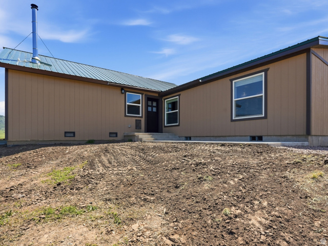8066 North Valley View Heights Preston, ID 83263 - Photo 3 of 34 Single-story residence featuring a brown siding exterior, dark trim, and a metal roof