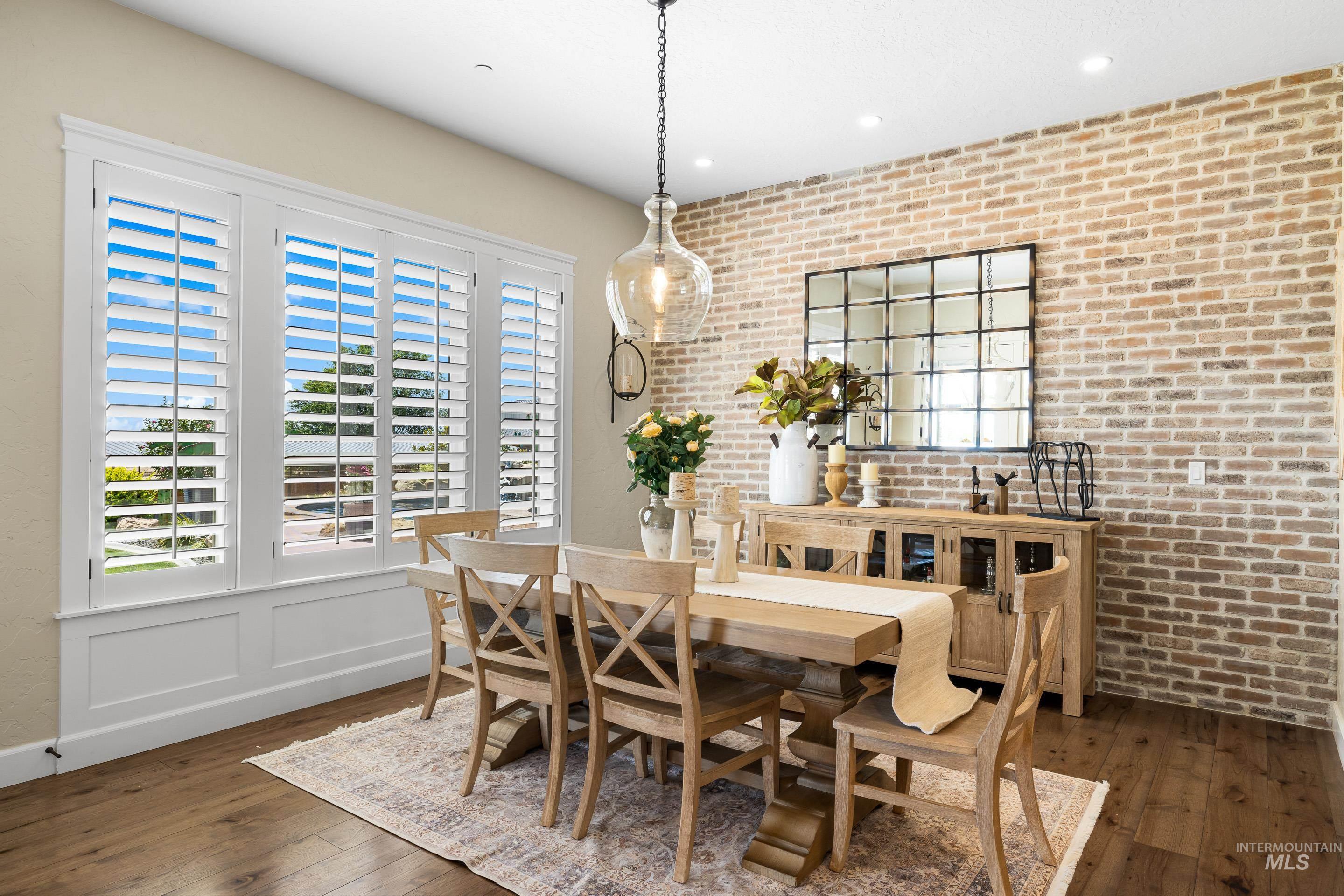 9819 Foothill Road Middleton, ID 83644 - Photo 23 of 49 Dining area with brick wall, wood-type flooring, and recessed lighting