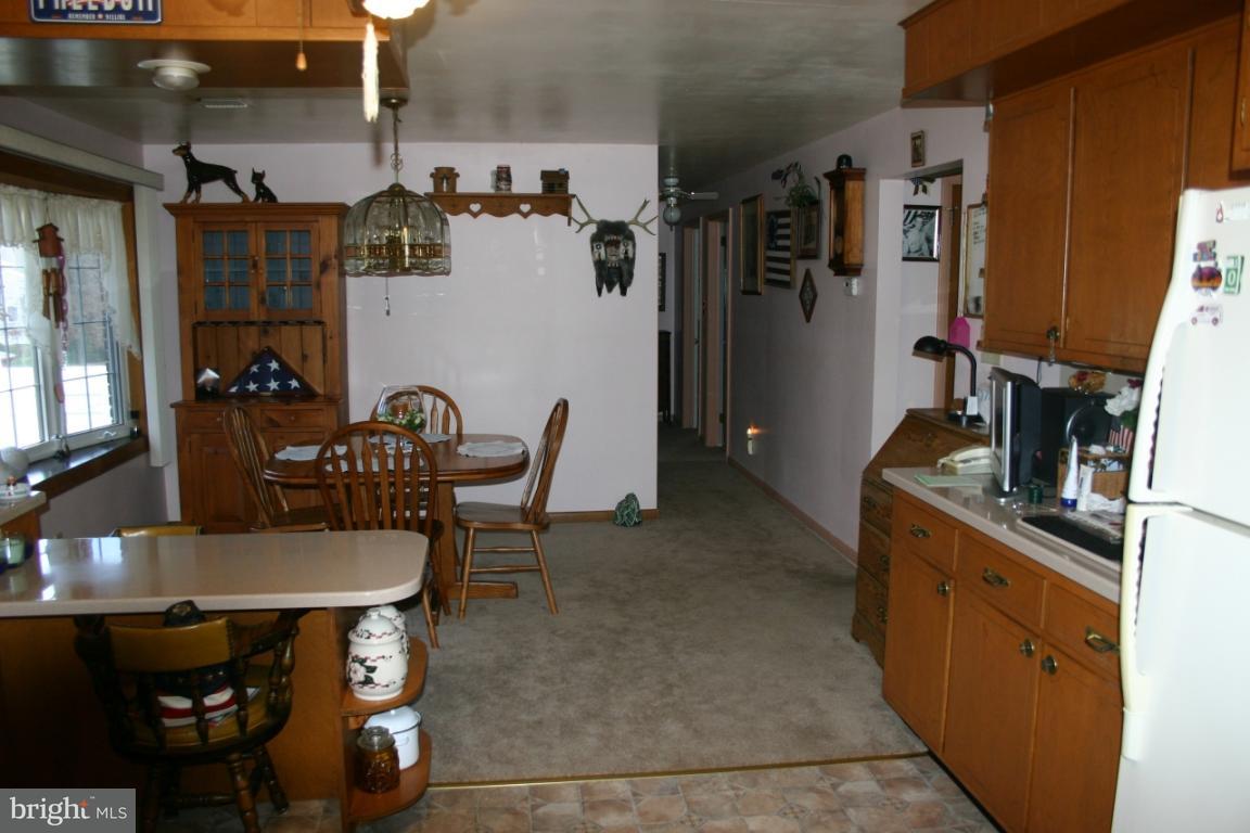270 North Penryn Road Manheim, PA 17545 - Photo 4 of 6 a kitchen with stainless steel appliances kitchen island granite countertop a table and chairs in it
