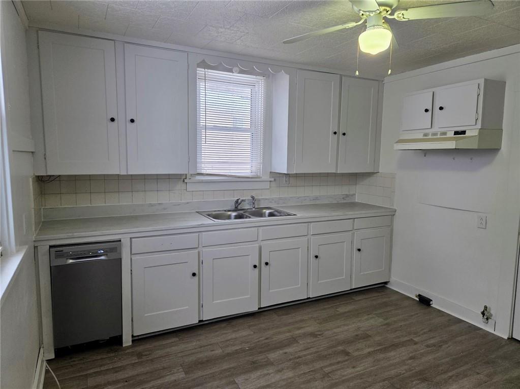 306 Spruce Street Butler, PA 16001 - Photo 15 of 47 a kitchen with granite countertop white cabinets white appliances with a sink and dishwasher