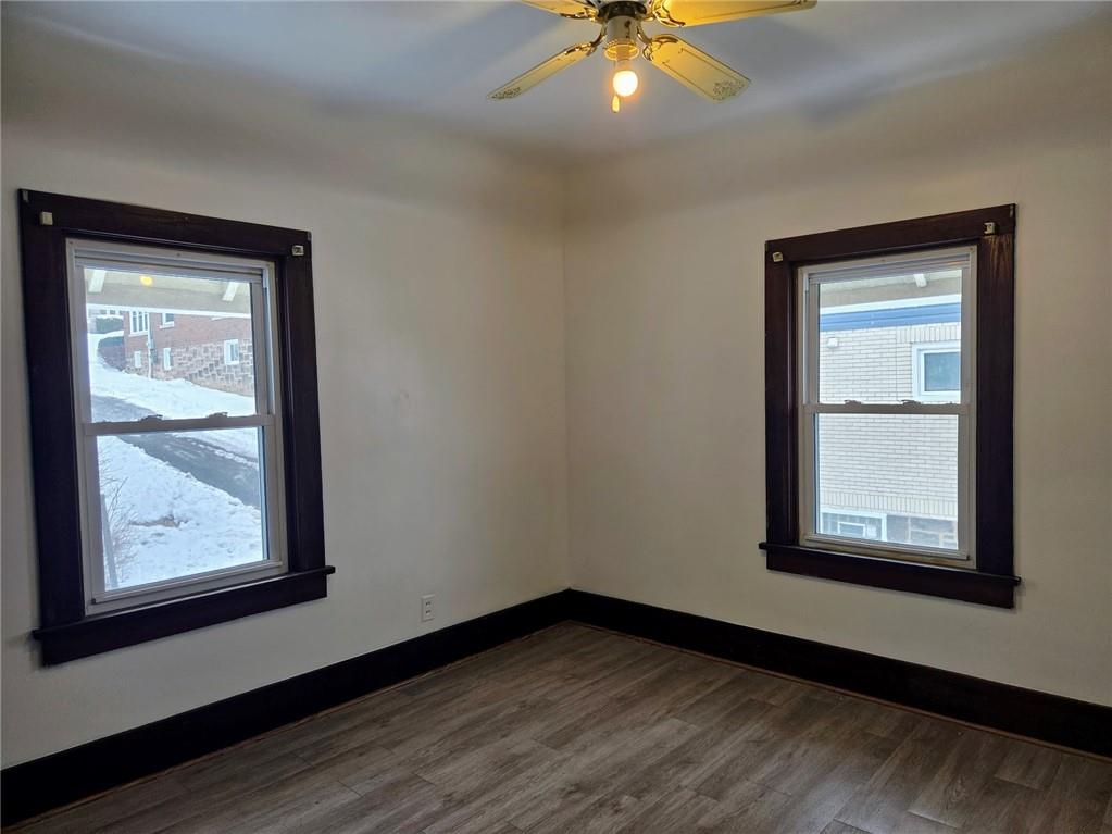 306 Spruce Street Butler, PA 16001 - Photo 23 of 47 an empty room with wooden floor and windows