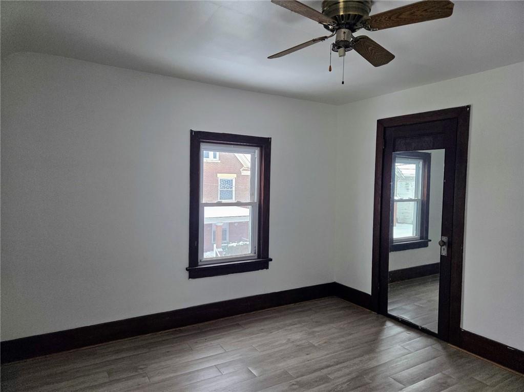 306 Spruce Street Butler, PA 16001 - Photo 28 of 47 an empty room with wooden floor closet and windows