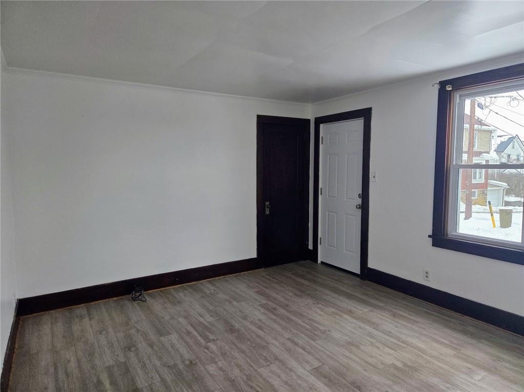 306 Spruce Street Butler, PA 16001 - Photo 3 of 47 an empty room with wooden floor and windows