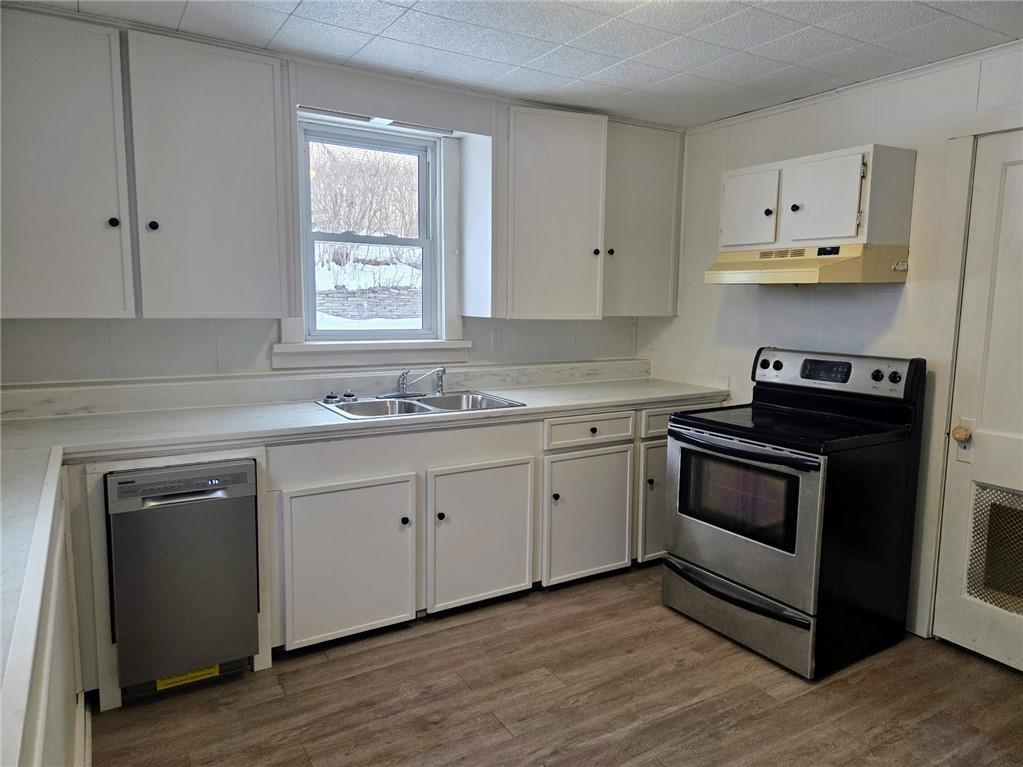 306 Spruce Street Butler, PA 16001 - Photo 9 of 47 a kitchen with cabinets appliances and a window
