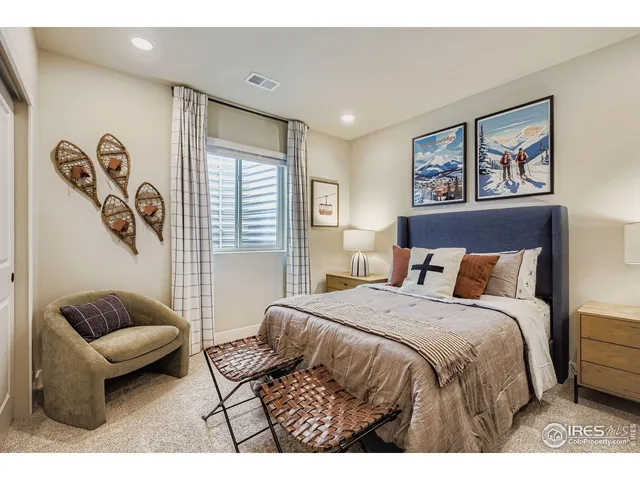 a bedroom with a bed couch and a window