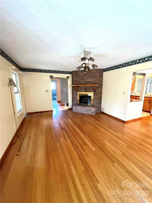 2525 Holbrook Road Fort Mill, SC 29715 - Photo 11 of 29 a view of empty room with wooden floor and fireplace