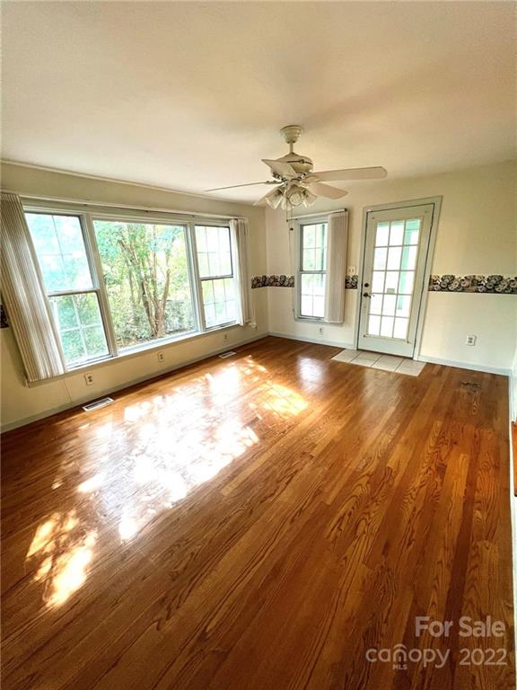 2525 Holbrook Road Fort Mill, SC 29715 - Photo 12 of 29 a view of an empty room with wooden floor and a window