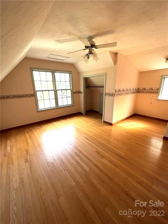 2525 Holbrook Road Fort Mill, SC 29715 - Photo 19 of 29 an empty room with wooden floor chandelier and windows