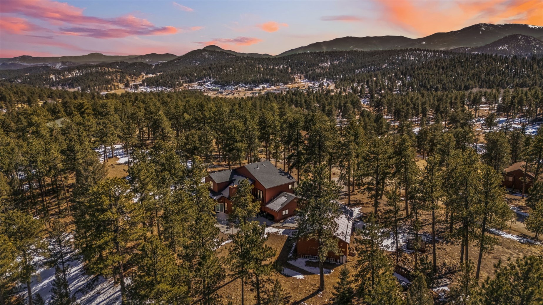 109 Old Corral Road Bailey, CO 80421 - Photo 49 of 50 Aerial view at dusk with a mountain view and a view of trees