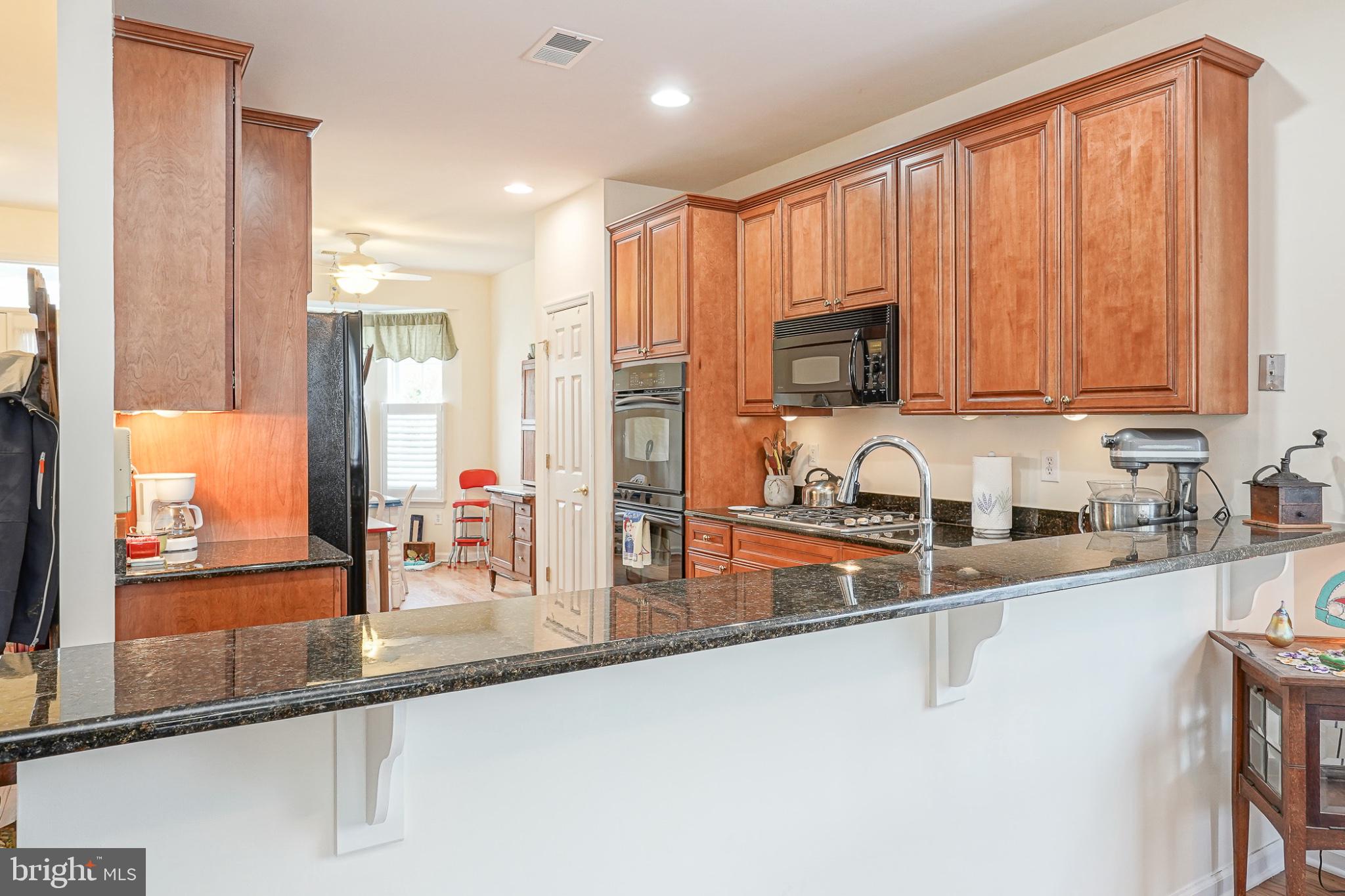213 Limerick Street Absecon, NJ 08205 - Photo 9 of 39 Modern kitchen with rich wood accents.