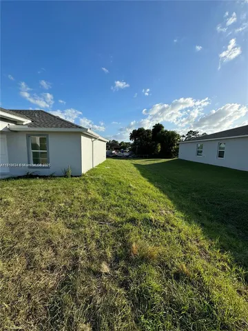 a view of a backyard of the house