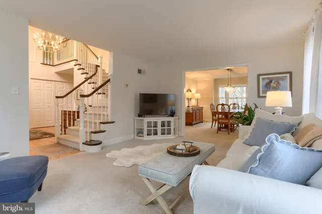 a view of a dining room with furniture and chandelier