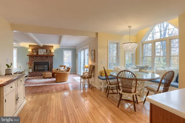 a living room with furniture large window and a fireplace