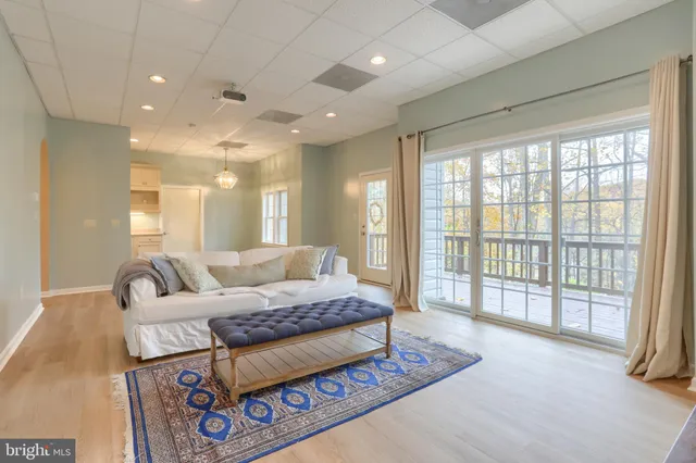a living room with furniture and a floor to ceiling window