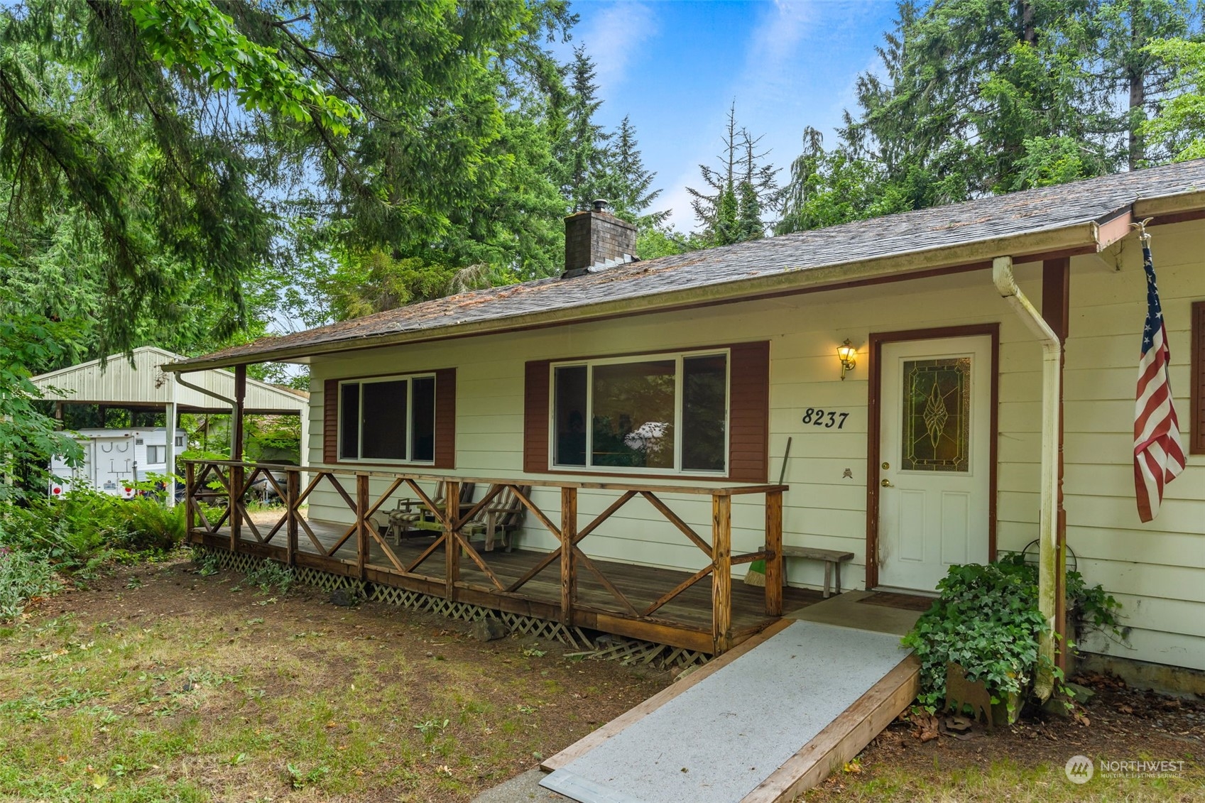 8237 Mullen Road Southeast Olympia, WA 98503 - Photo 4 of 39 a view of a house with backyard sitting area and garden