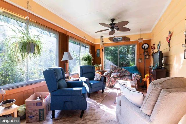 a living room with patio furniture and a large window