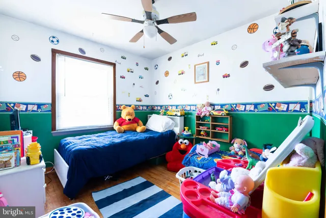 a bed room with two beds and a play room