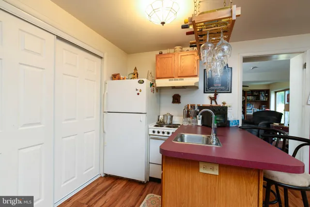 a kitchen with a refrigerator and a table