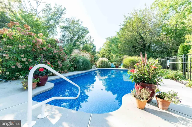 a view of a balcony with chairs potted plants