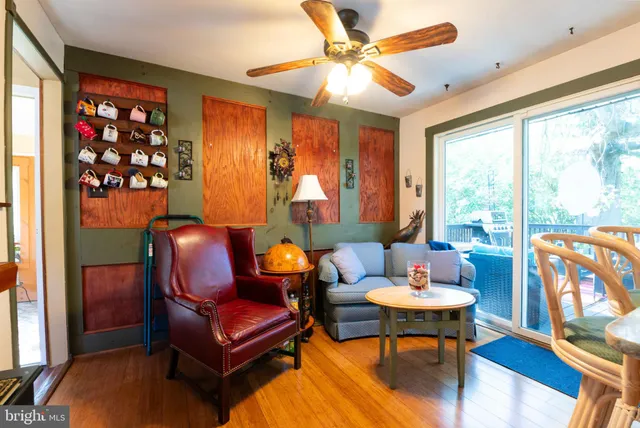 a living room with furniture a rug and a large window
