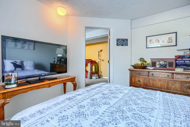 a bedroom with a bed and a dresser in it