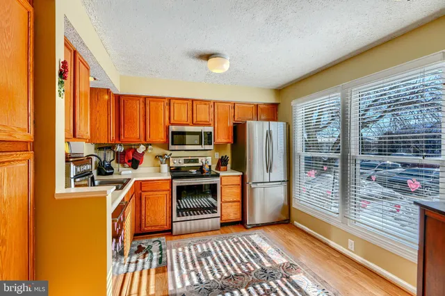 a kitchen with a refrigerator a stove top oven a sink and dishwasher