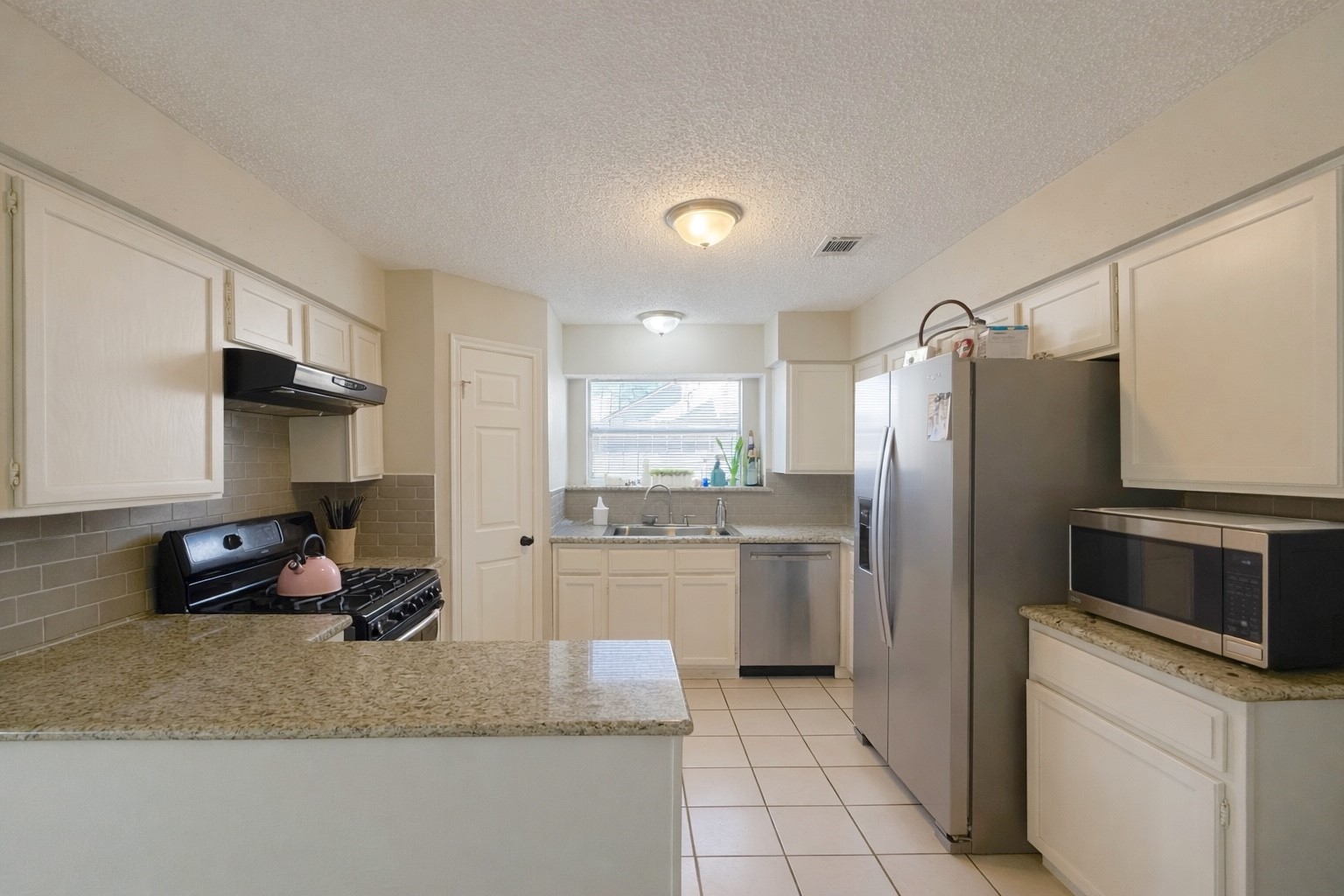 17007 Spruce Run Drive Spring, TX 77379 - Photo 11 of 23 a kitchen with stainless steel appliances granite countertop a refrigerator sink and stove