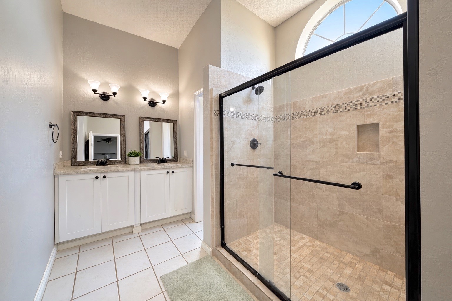 17007 Spruce Run Drive Spring, TX 77379 - Photo 14 of 23 a bathroom with a shower a mirror and a sink