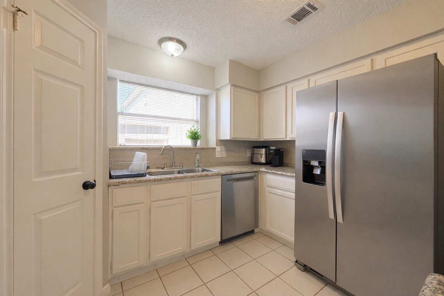 17007 Spruce Run Drive Spring, TX 77379 - Photo 10 of 23 a kitchen with white cabinets and white appliances