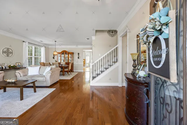 a living room with furniture and wooden floor