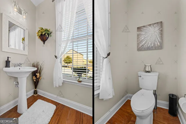 a open kitchen with stainless steel appliances granite countertop a sink dishwasher and white cabinets with wooden floor