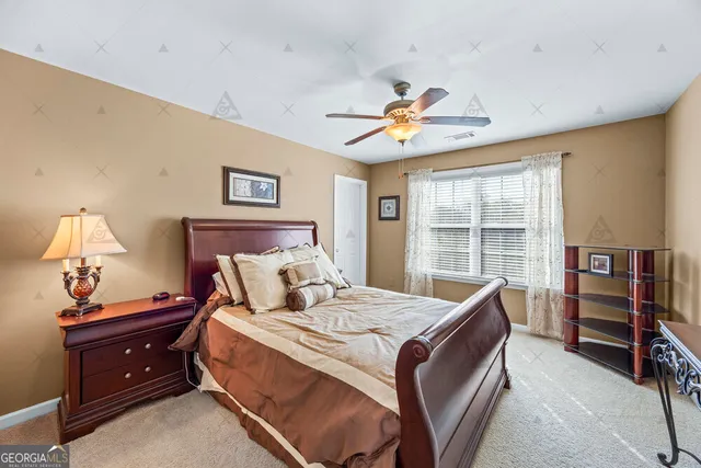 a white toilet next to a bathroom