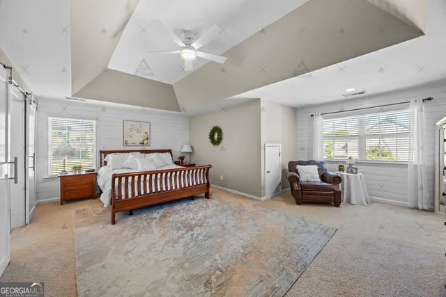 a spacious bathroom with a double vanity sink a large mirror a bathtub and shower