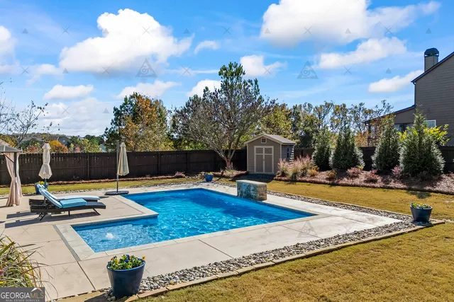 a view of a house with backyard and sitting area