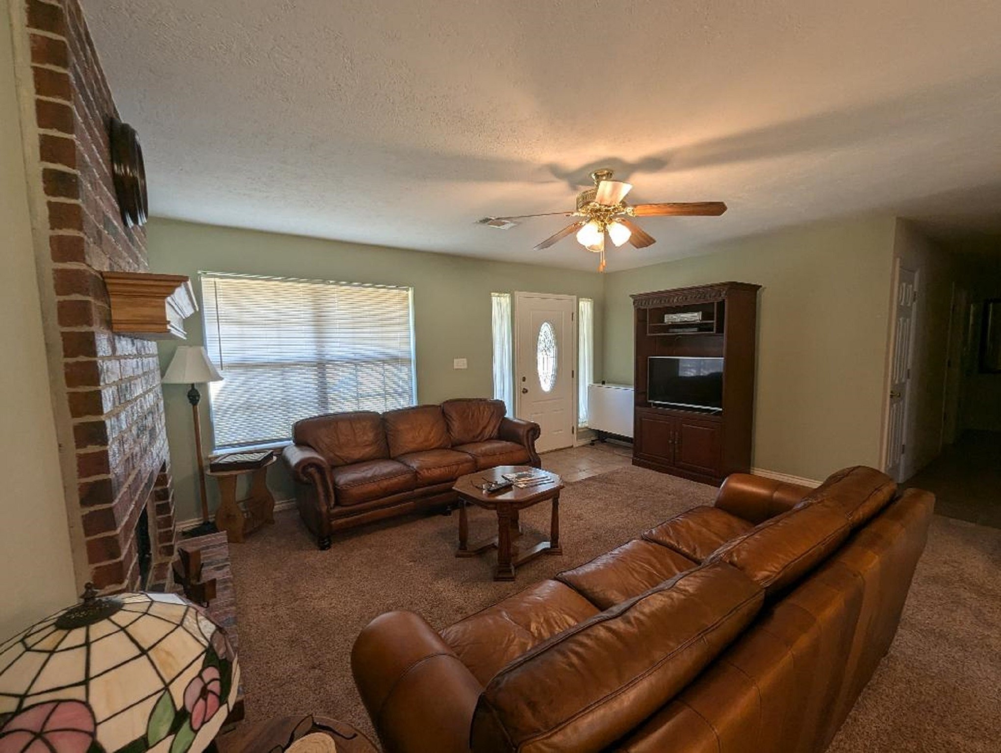 141 Coral Gables Trinity, TX 75862 - Photo 11 of 42 a living room with furniture a fireplace and a window