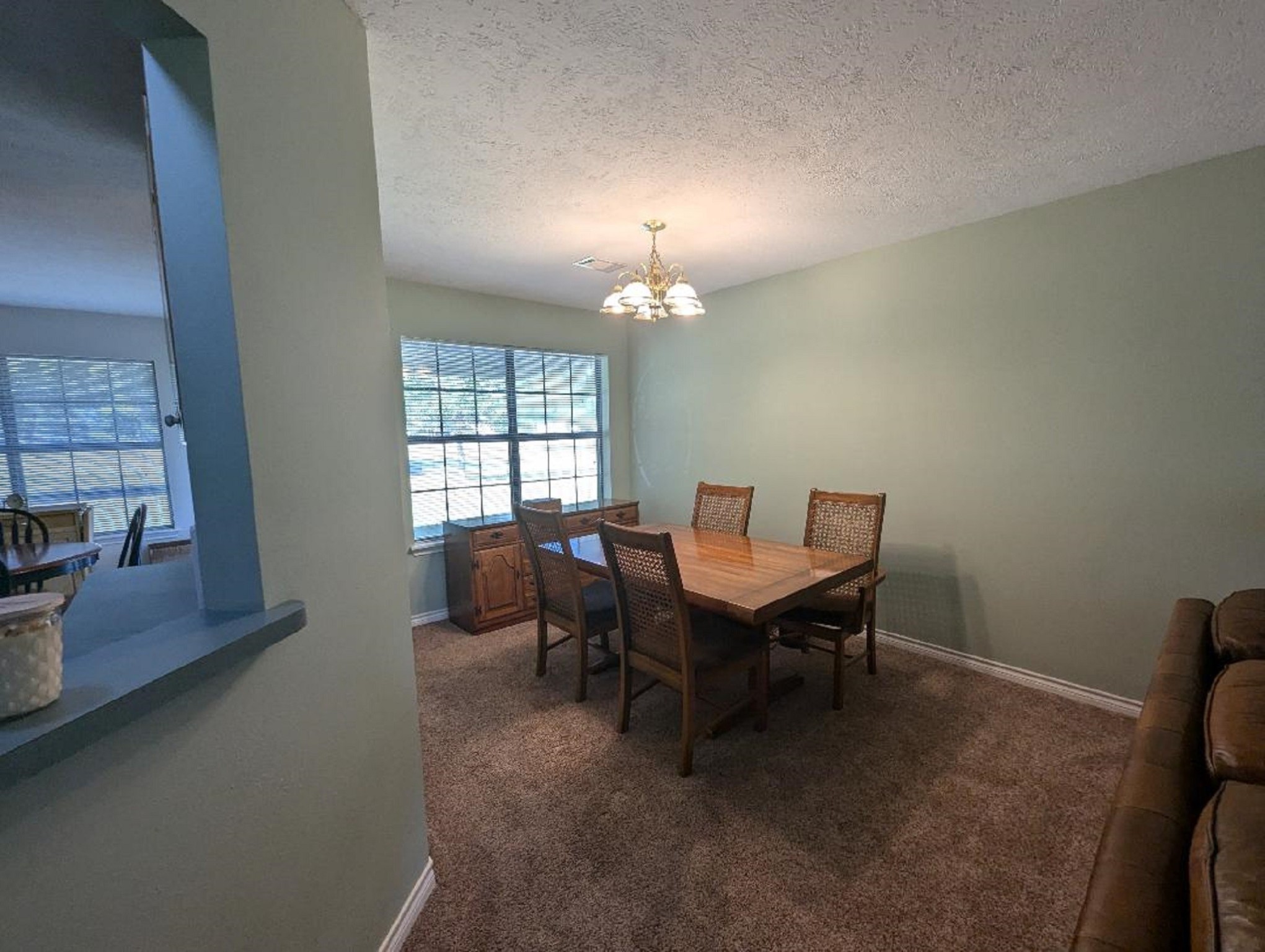 141 Coral Gables Trinity, TX 75862 - Photo 13 of 42 a view of a dining room with furniture and chandelier