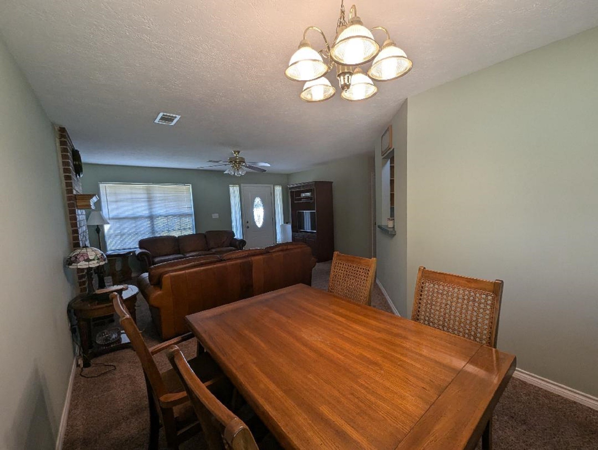 141 Coral Gables Trinity, TX 75862 - Photo 15 of 42 a bedroom with a bed and a chandelier