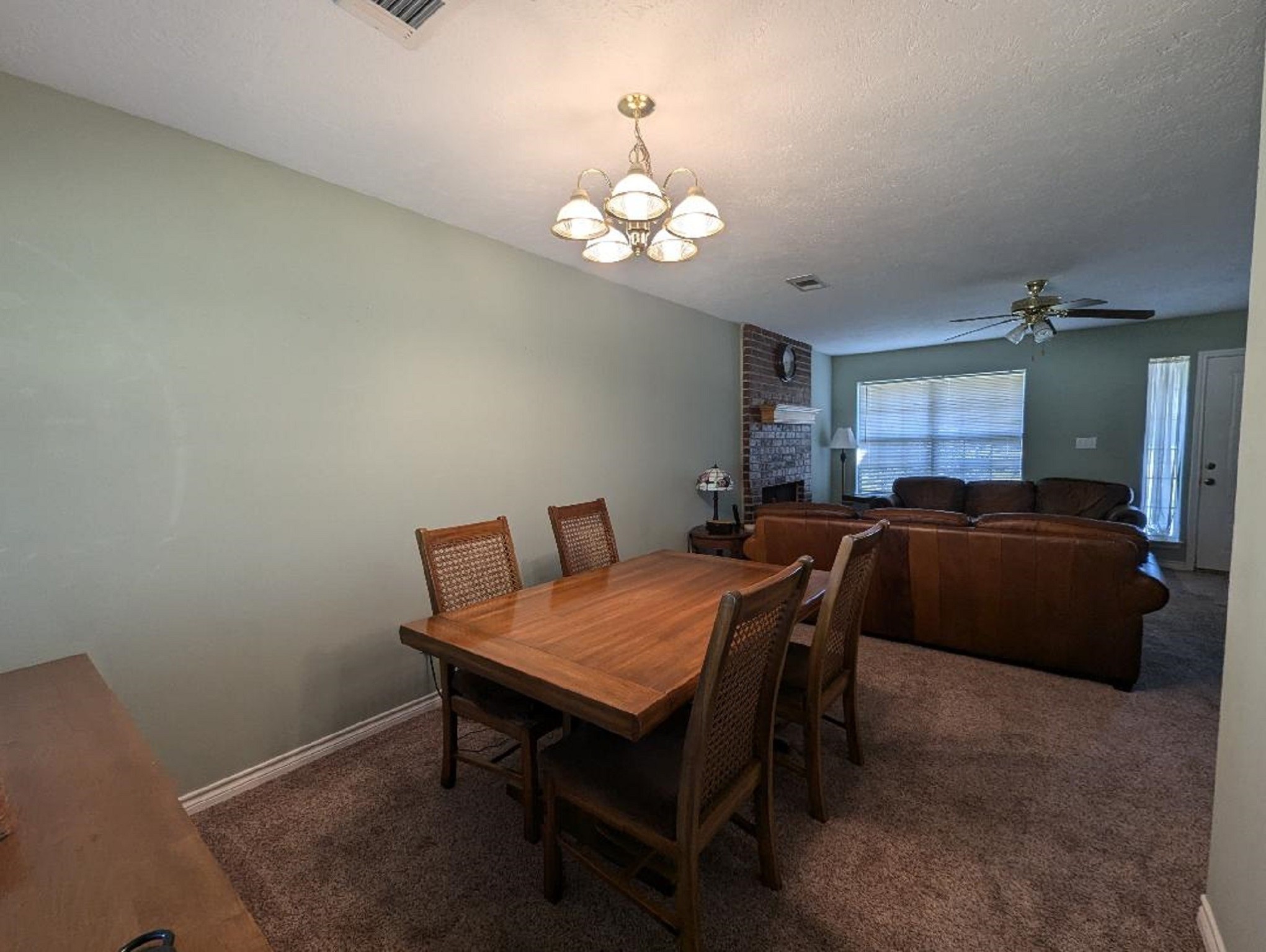 141 Coral Gables Trinity, TX 75862 - Photo 16 of 42 a view of a dining room with furniture and chandelier