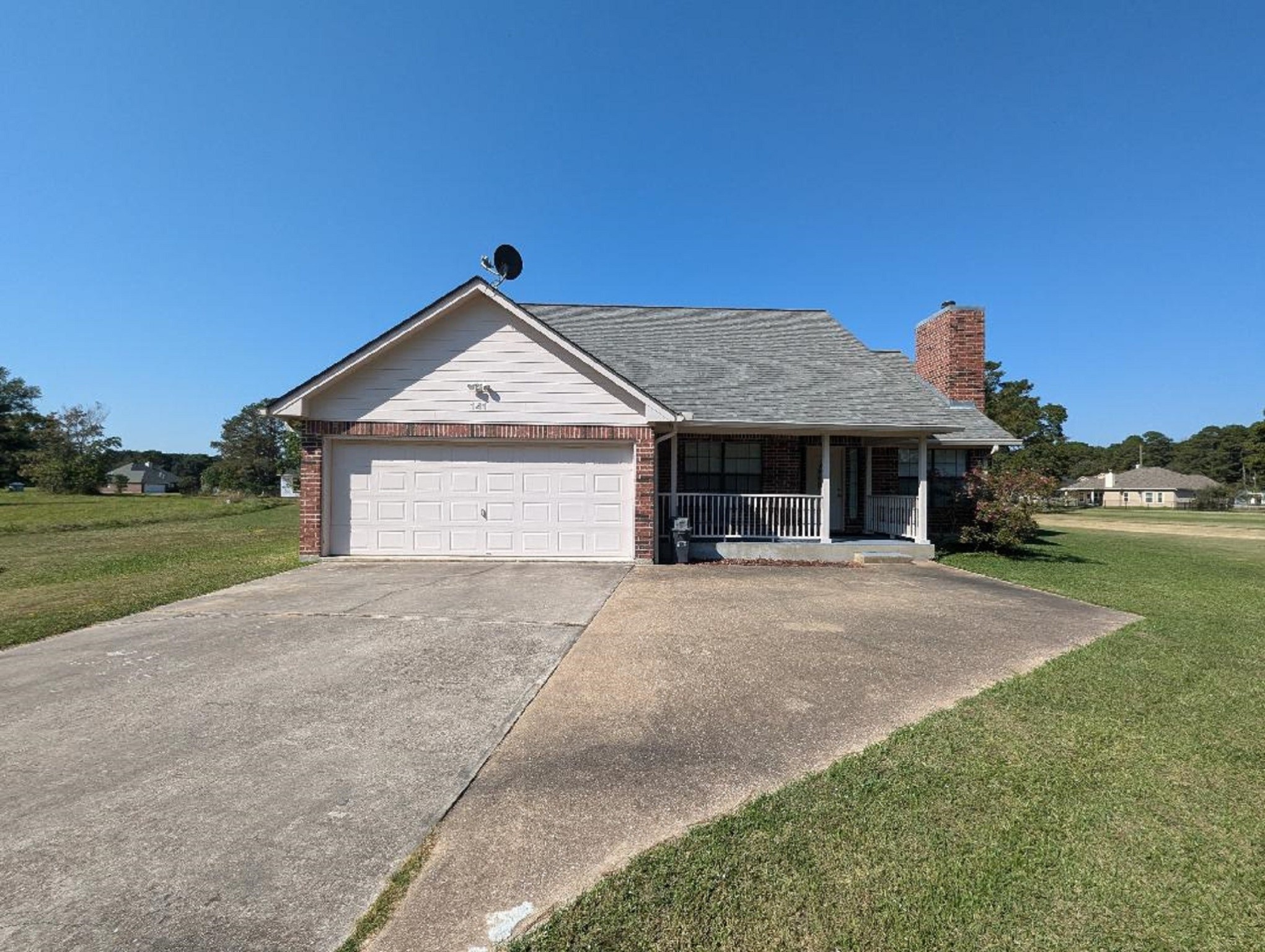 141 Coral Gables Trinity, TX 75862 - Photo 2 of 42 a front view of a house with a yard and garage