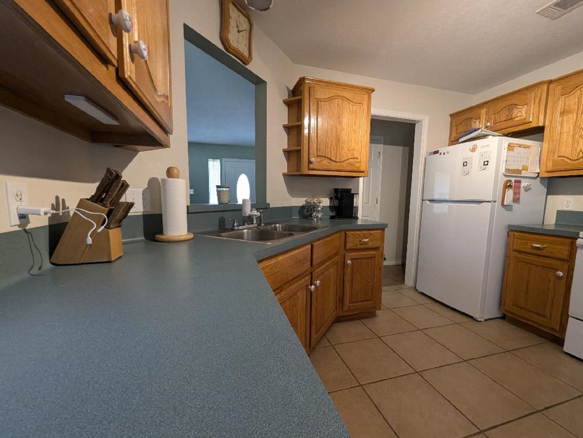 141 Coral Gables Trinity, TX 75862 - Photo 21 of 42 a kitchen with a refrigerator a stove and a sink