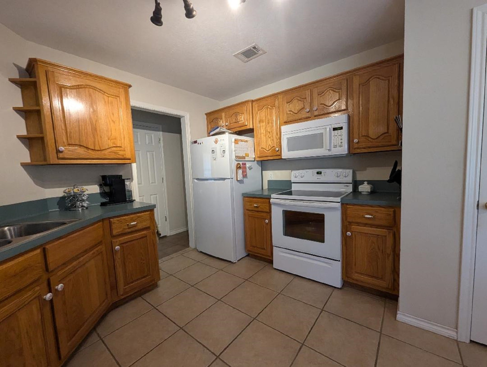 141 Coral Gables Trinity, TX 75862 - Photo 23 of 42 a kitchen with granite countertop cabinets stainless steel appliances and a sink