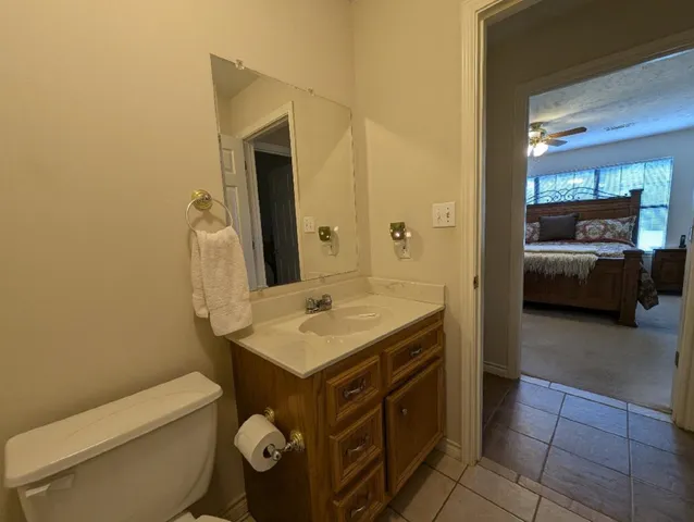 a bathroom with a toilet a sink and a mirror