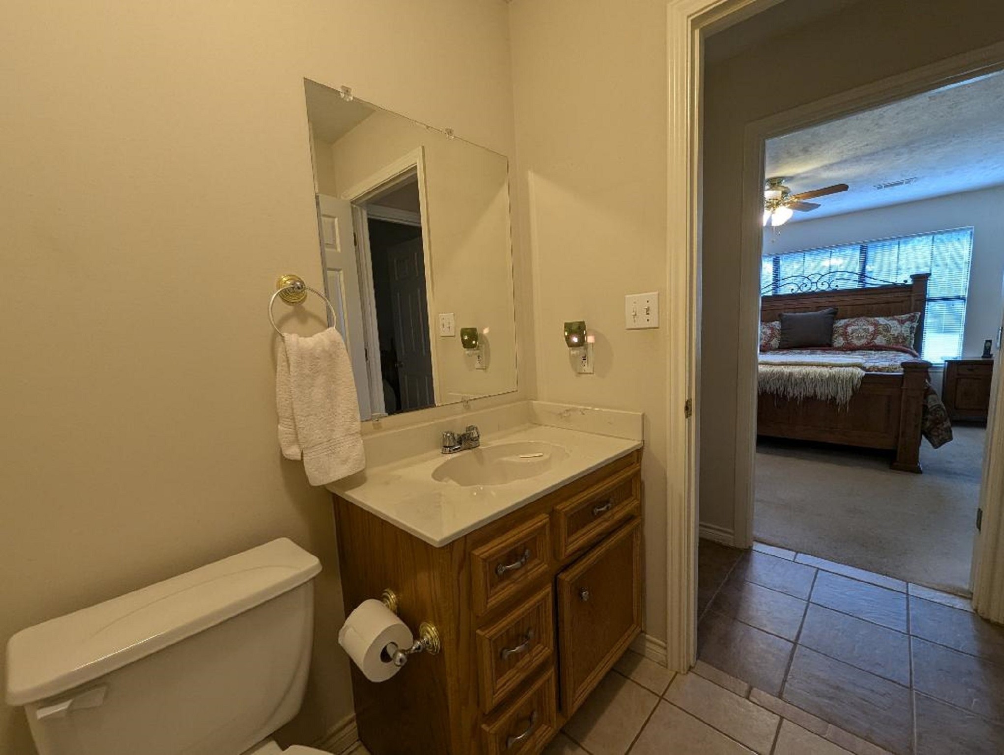 141 Coral Gables Trinity, TX 75862 - Photo 25 of 42 a bathroom with a toilet a sink and a mirror