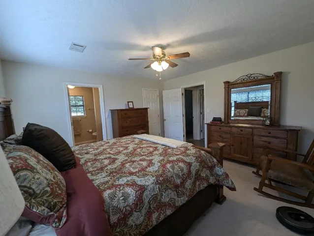 a bedroom with a bed and dresser with mirror