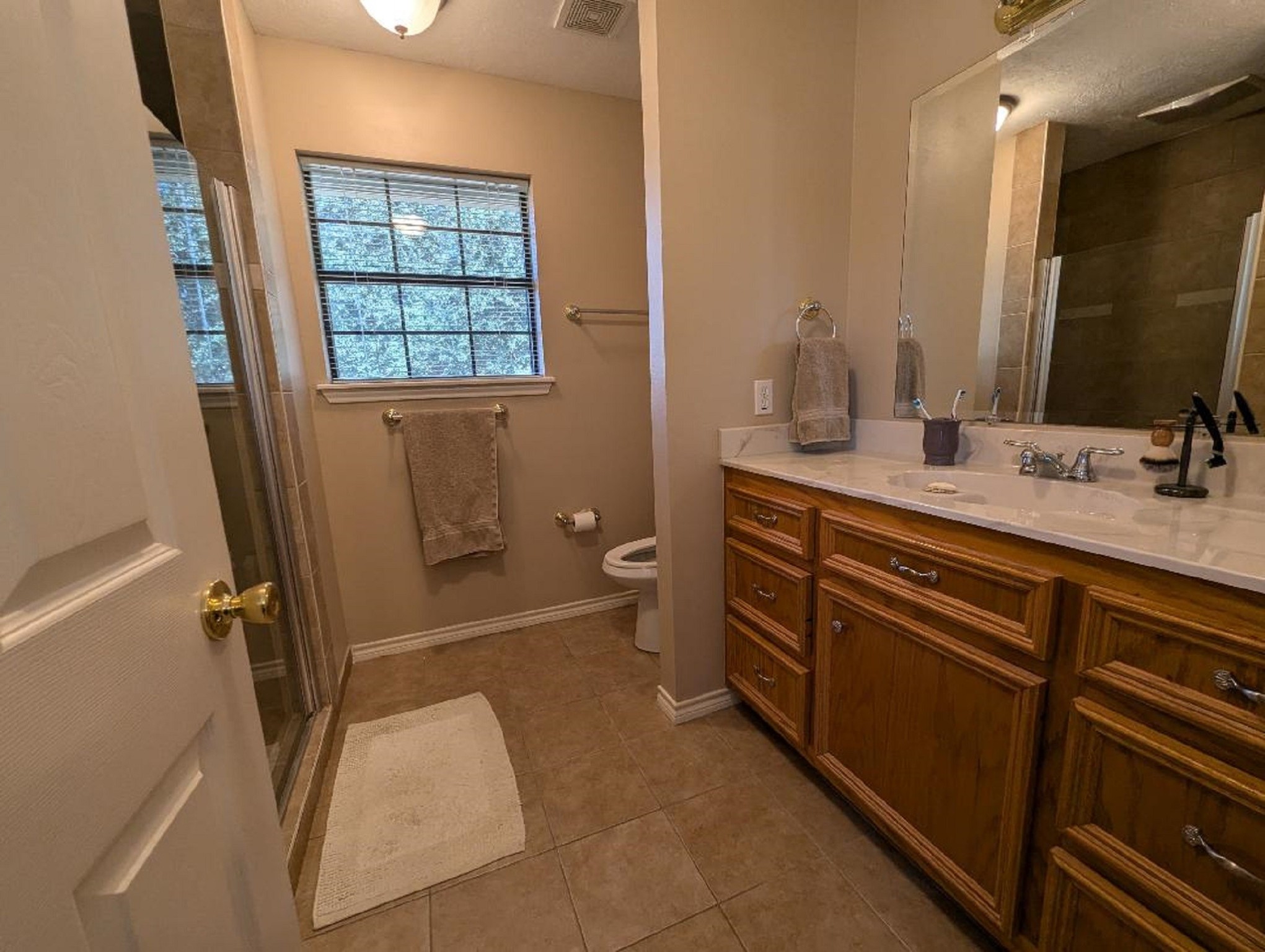 141 Coral Gables Trinity, TX 75862 - Photo 34 of 42 a bathroom with a granite countertop sink toilet and shower