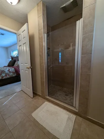 a bathroom with a shower and closet